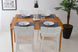 foto ambientada mesa de cozinha extensivel pina na cor cerezo aberta com 4 cadeiras uma em volta