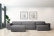 foto ambientada do sofá puff para sala módulo maraú na cor cinza claro visto de frente com sofa no fundo em sala de estar